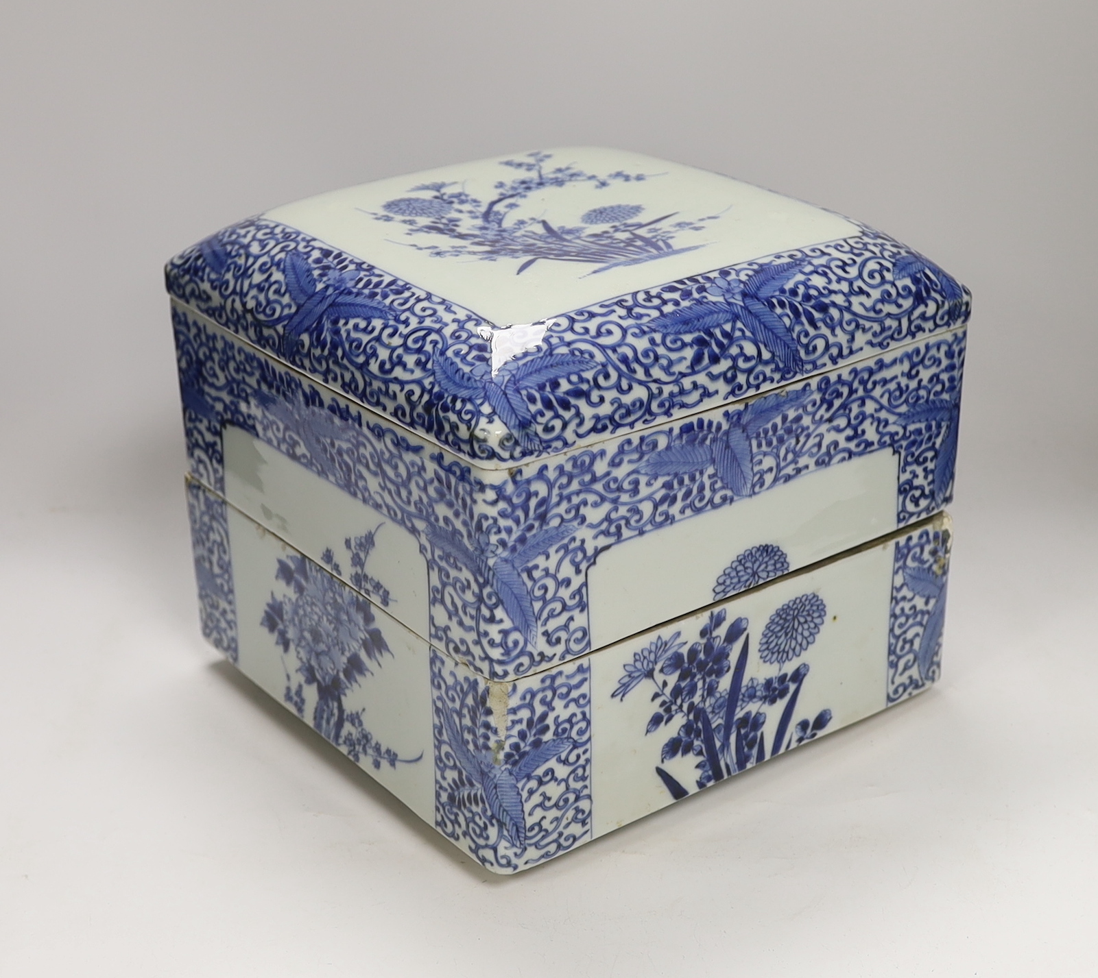 A Japanese blue and white floral, two tier food container with cover, 23cm high